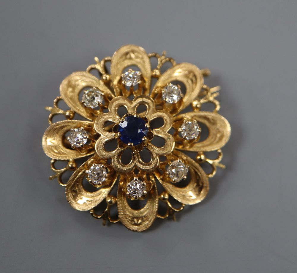 A French yellow metal (poincon mark for 18ct), sapphire and diamond set flower head pendant brooch,